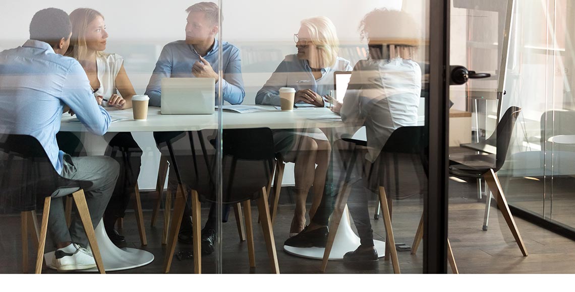 Business people negotiating at boardroom behind closed doors