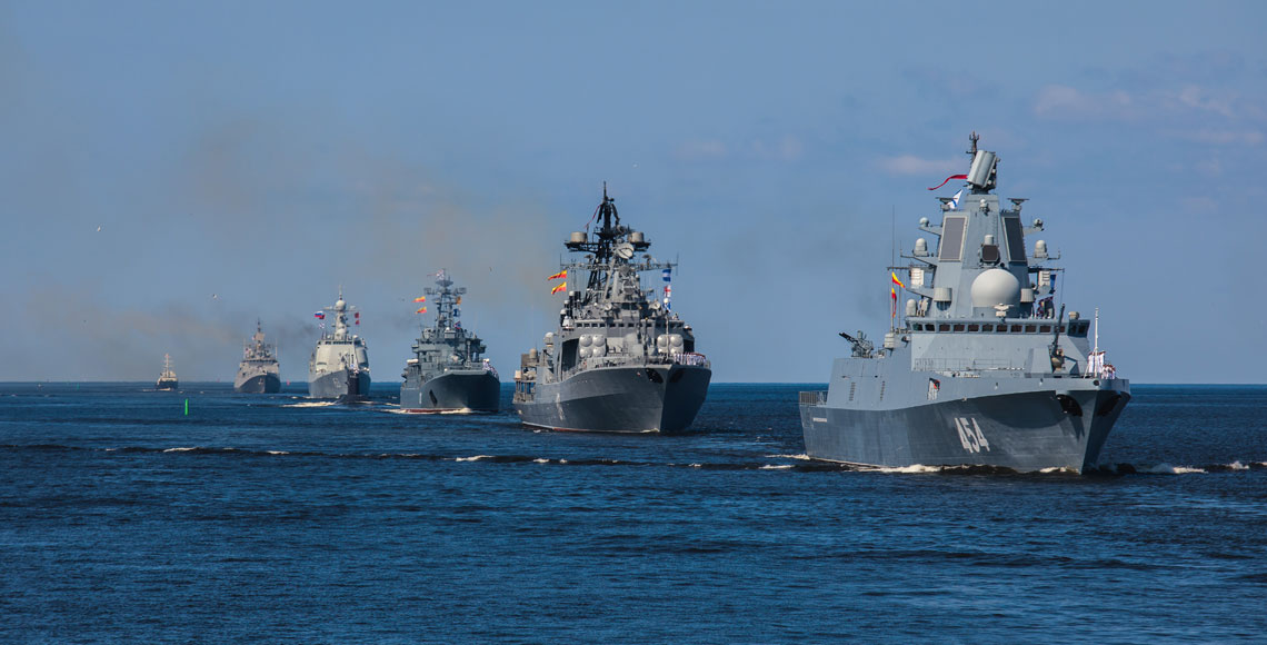 A line ahead of modern russian military naval battleships warships in the row, northern fleet and baltic sea fleet, summer sunny day