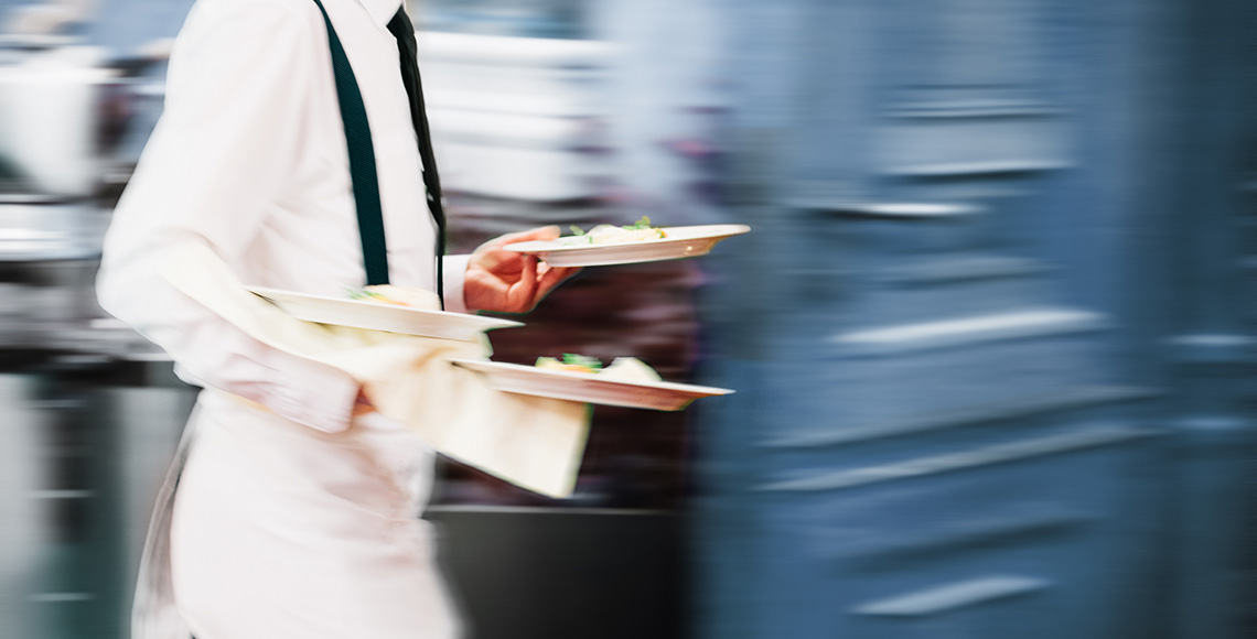 Waiter Serving In Motion On Duty in Restaurant Long Exposure