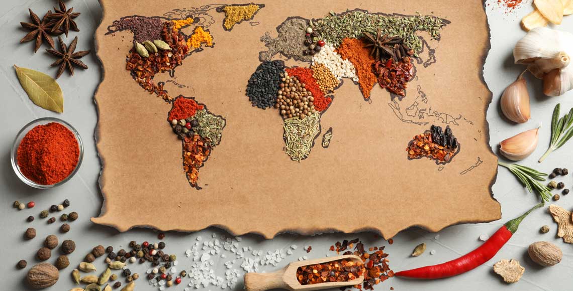 Paper with world map made of different aromatic spices on gray background, flat lay